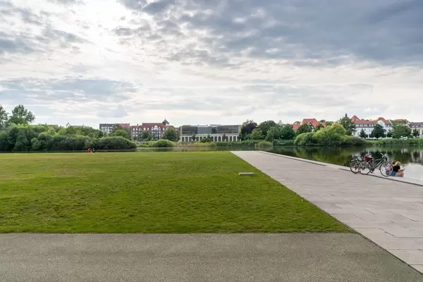 Green lawn in the park next to the lake and Schwerin Castle in the beautiful city of Schwerin