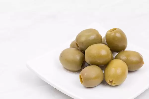 Green Olives served on the plate with copy space