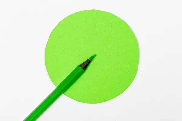 Green pencil and green circle on a white background-the concept of the right choice (Flip 2019)