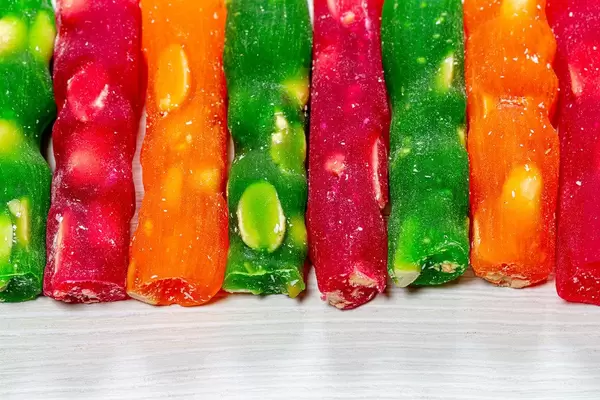 Green, red and orange churchkhela with nuts (Flip 2019)