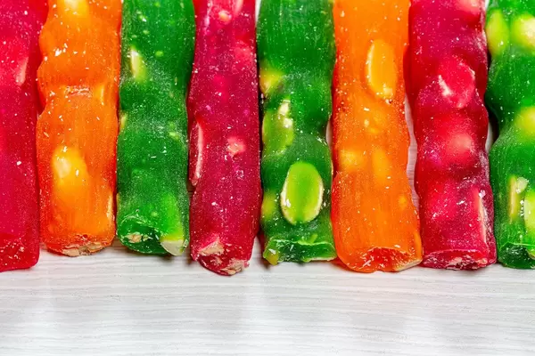 Green, red and orange churchkhela with nuts