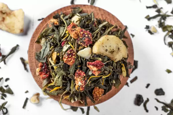 Green tea with pieces of dried banana and strawberry. Top view