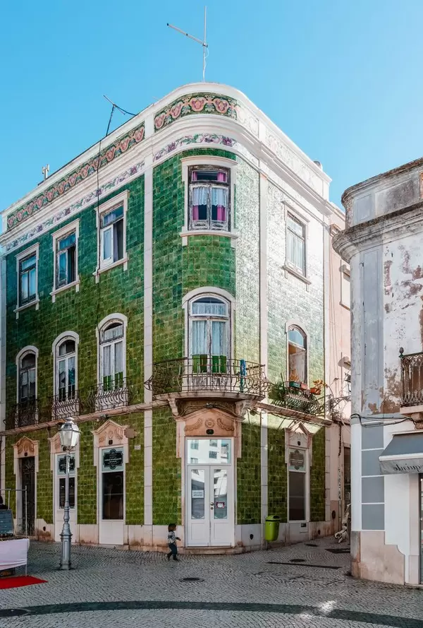 Green tile building on the corner in Lagos city center  Flip 2019