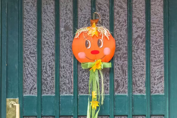 Green wooden door with handmade Halloween decoration