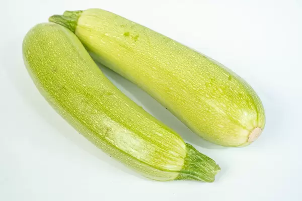 Green Zucchini above white background (Flip 2019)