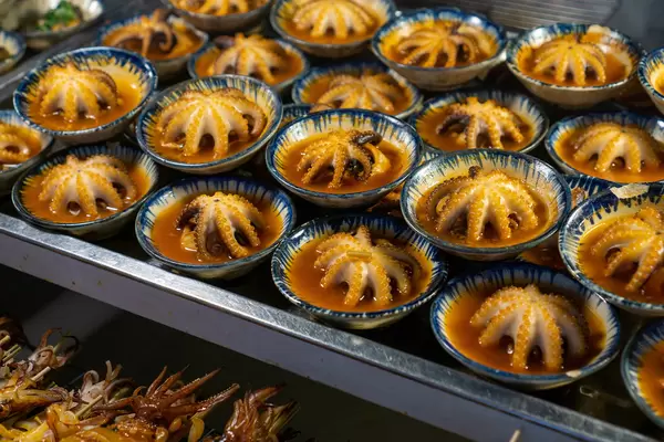 Grilled Baby Octopus with Sauce in Small Ceramic Bowls at a Street Food Vendor at Phu Quoc Night Market, Vietnam