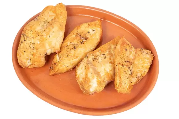 Grilled Chicken breasts served on the plate above white background (Flip 2019)