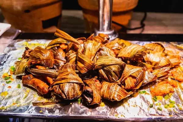 Grilled chicken wrapped in leaves