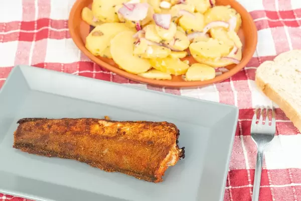 Grilled Hake fish served on the plate with Potatoes salad (Flip 2019)