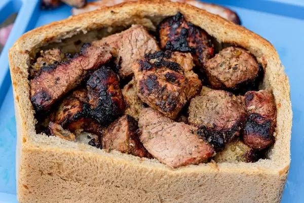 Grilled meat in a loaf of bread, close up