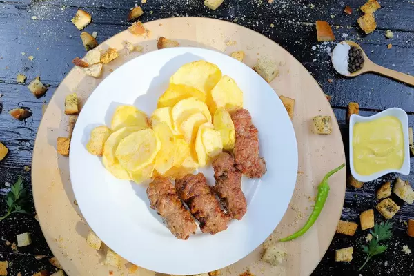 Grilled minced meat rolls with pan fried potatoes