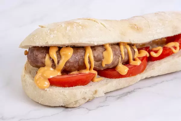 Grilled Sausage in bread with tomato on the white background