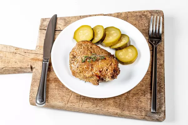 Grilled shashlik with pickled cucumber on the kitchen board (Flip 2020)