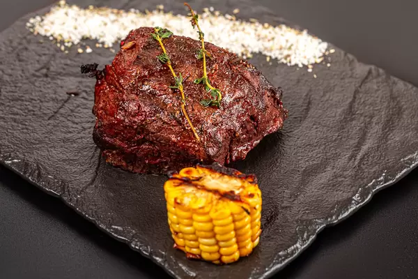 Grilled steak filet mignon served with grilled corn and thyme