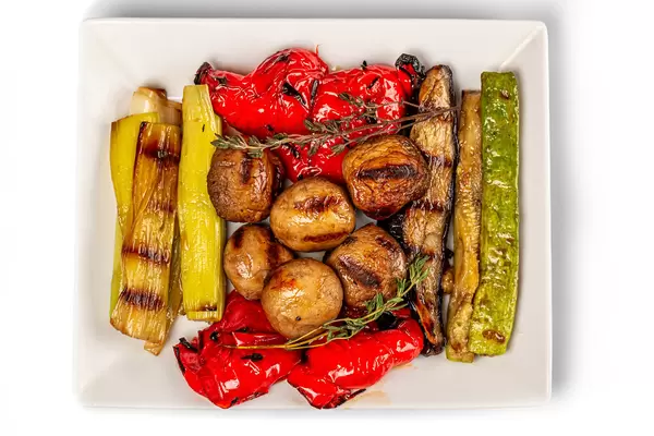 Grilled vegetables mix on plate, top view