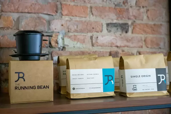 Grinded Robusta Coffee, Coffee Beans and Vietnamese Coffee Filter for Sale at The Running Bean Cafe in Ho Chi Minh City, Vietnam