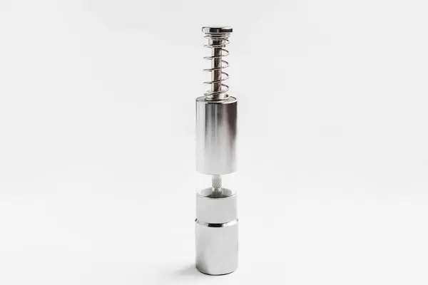 Grinding salt and pepper shaker on white background.