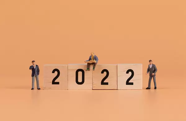 Group of businessman and 2022 text on wooden blocks