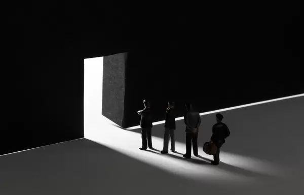 Group of businessman standing in front of a big doors