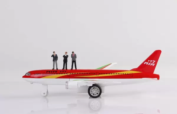 Group of businessman standing on toy airplane