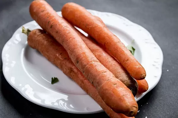 Group of carrots in a white plate, close up
