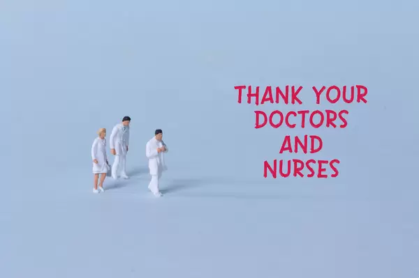Group of doctors with red Thank you doctors and nurses text