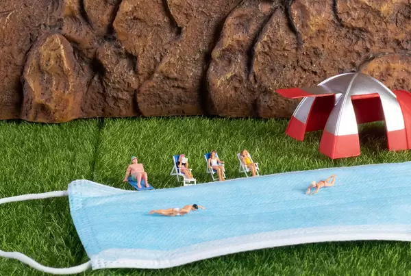 Group of miniature people relaxing in the nature