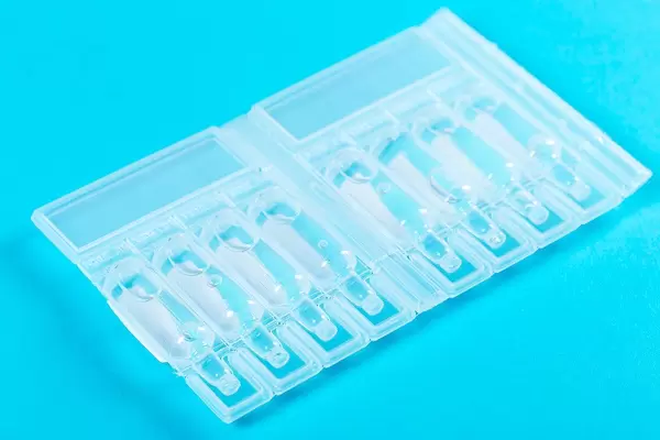 Group of modern plastic ampules on blue background