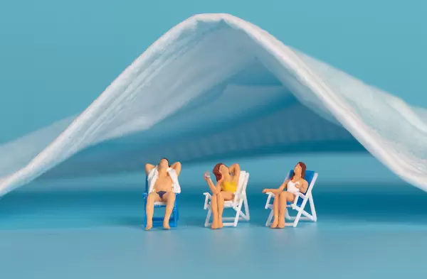 Group of people relaxing under medical face mask