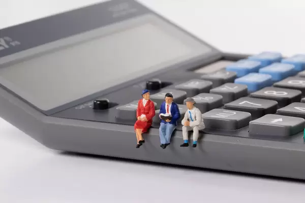 Group of people sitting on calculator