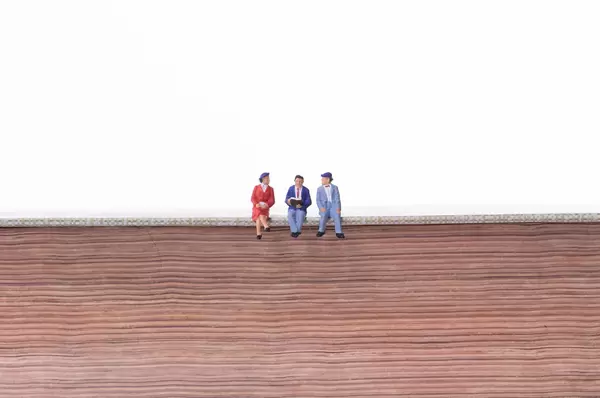 Group of people sitting on old book with white background
