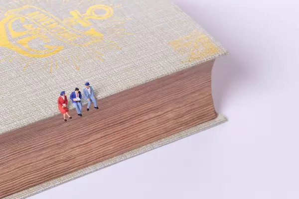 Group of people sitting on old book