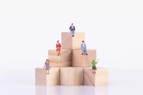Group of people sitting on wooden blocks