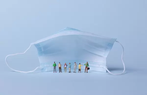 Group of people standing under face mask