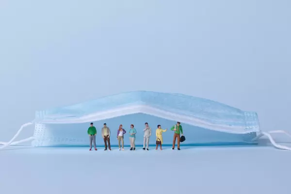 Group of people standing under medical face mask