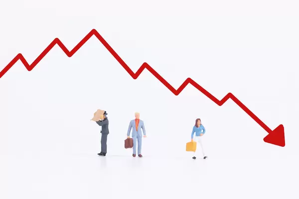 Group of people with red down graph