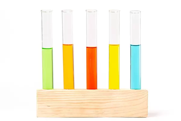 Group of test tubes with a colored liquids in a wooden rack