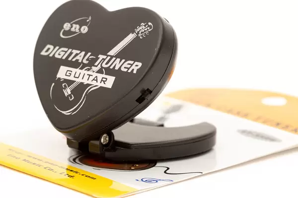 Guitar and Bas digital Tuner isolated above white background