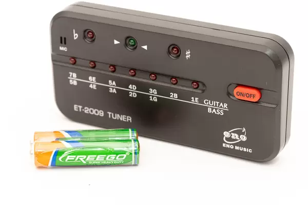 Guitar Tuner with batteries isolated above white background