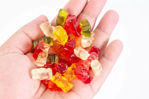 Gummy Bears in the hand above white background