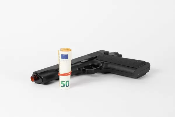 Gun and money concept