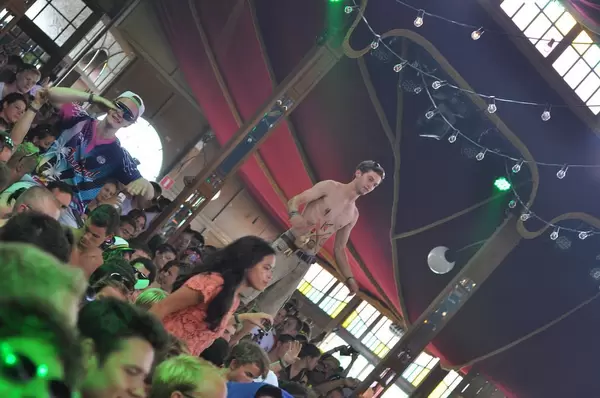 Guy standing on mate's shoulders - Tomorrowland music festival 2014