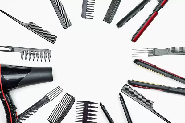 Hairdresser tools on white background with copy space in center