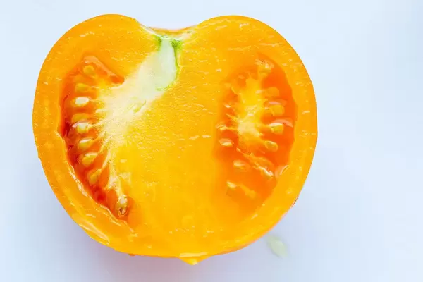Half a fresh yellow tomato. Top view