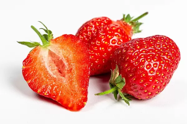 Half and whole strawberries, close-up