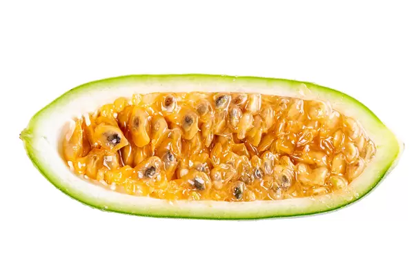 Half exotic tropical fruit called curuba (passiflora tripartita) on white background