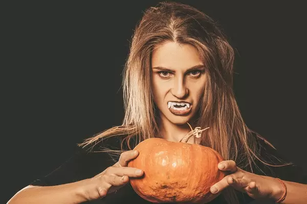 Halloween background with vampire and pumpkin