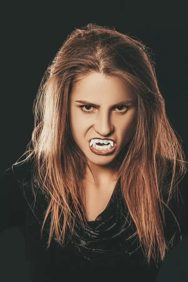 Halloween vampire beautiful woman over black