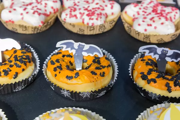 Halloweengebäck: Dots mit oranger Glasur und Fledermaus-Streusel