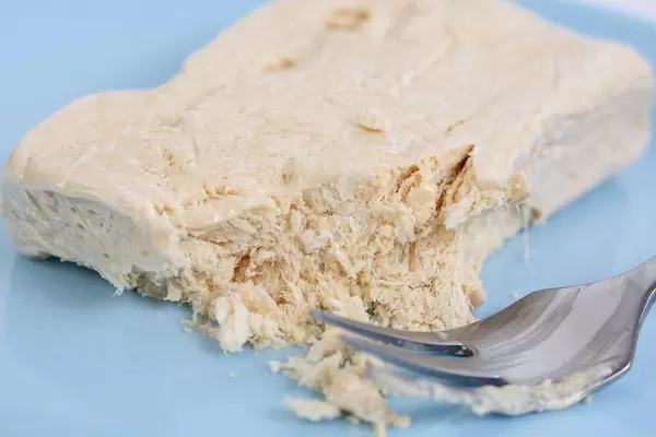 Halva candy with Vanilla with fork on the plate
